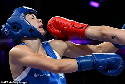 Carini (pictured) was mauled in the clash - which comes amid a gender row over her opponent, who was banned from fighting at the world championships after being deemed 'biologically male'