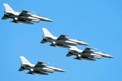U.S. made F-16 fighter jets fly in the sky over Poland’s capital as they take part in a massive military parade