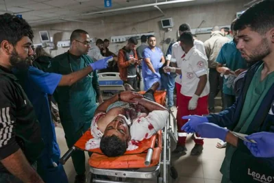 Medics carry a wounded man after an Israeli army strike at a hospital in Deir al-Balah, Gaza, late Saturday Nov. 16, 2024. Israeli strikes in the Gaza Strip overnight killed 12 people, Palestinian medical officials said Sunday. (AP Photo/Abdel Kareem Hana)