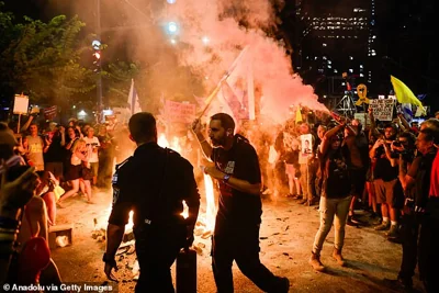 The rally, which organisers claim is the largest ever held in Tel Aviv, saw a 'small cadre of protesters' lighting bonfires and creating roadblocks