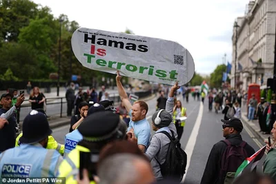 Counter protesters hold up a banner directed at those taking part in the Palestine Solidarity Campaign last month