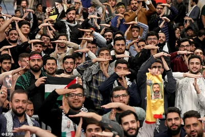 The crowd offered a raucous welcome to Khamenei, chanting: 'The blood in our veins is a gift to our leader!'