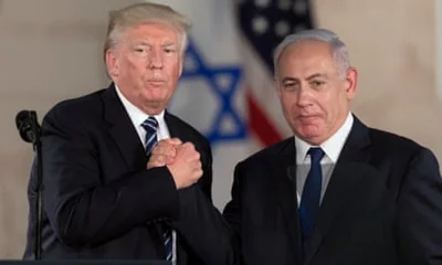 Donald Trump and Benjamin Netanyahu grasp each other’s hands