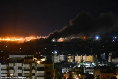 Smoke and flames rise into the Lebanon sky as an Israeli bombardment continues into the night