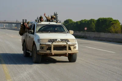 Fighters drive their vehicle on the international M5 highway in the area Zarbah which was taken over by anti-government fighters on November 29, 2024