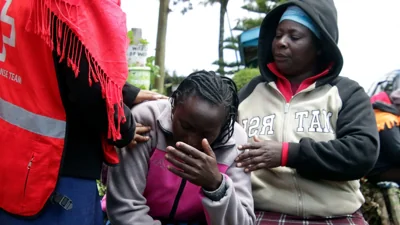 A woman cries following a fire in a school dormitory in Kenya that killed 17 students and seriously burned 13 others.