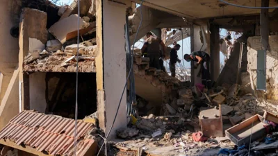 Civil defense workers inspect the rubble of a destroyed building hit in an Israeli airstrike on Tuesday night, in Barja, Lebanon, Wednesday, Nov. 6, 2024.