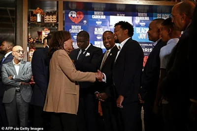 Kamala Harris greets attendess during a campaign stop at The Pit Authentic Barbecue restaurant in Raleigh, North Carolina, on October 12, 2024