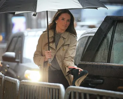 Donald Trump's assistant Margo Martin is seen leaving Trump Tower to heart to court. Martin did not travel in the same SUV as Trump but was part of the convoy of cars that followed. She was carrying her shoes as she entered the vehicle
