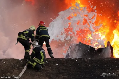 Firefighters work at the site damaged in a Russian drone strike overnight, on Saturday
