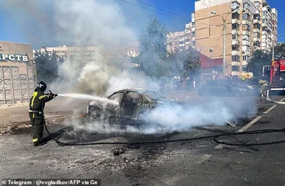 This undated handout photograph released on September 1, 2024, on the official Telegram account of the Belgorod region governor Vyacheslav Gladkov, shows a firefighter extinguishing a car after a recent shelling by a Ukrainian strike in Belgorod