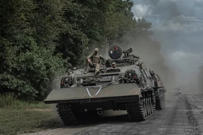 Ukrainian troops ride an infantry vehicle into Russia