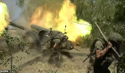 A still image taken from an undated handout video made available by the Russian Defence Ministry Press-Service on 23 August 2024 shows Russian servicemen firing a 122-mm howitzer D-30 towards Ukrainian positions at an undisclosed location