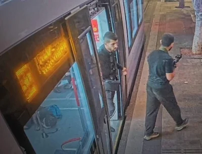 Pictured: Men, holding weapons, on the streets of Tel Aviv