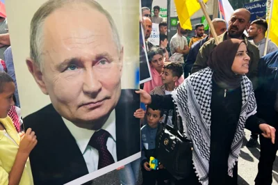 Palestinians hold a picture of the Russian President Vladimir Putin during a protest in support of the people of Gaza, as the conflict between Israel and Hamas continues, in Hebron in the Israeli-occupied West Bank, October 20, 2023. REUTERS/Yosri Aljamal