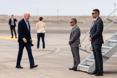 the American president walking toward stairs leading into Air Force One.