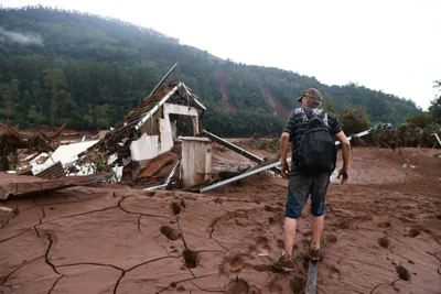 A man walks by a farm destroyed by the currents of the flash floods caused by heavy rains in Jacarezinho, Rio Grande do Sul state, Brazil, May 5, 2024. REUTERS/Diego Vara