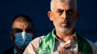 FILE - Yahya Sinwar, Palestinian leader of Hamas in the Gaza Strip, places his hand over his heart on stage after greeting supporters at a rally on May 24, 2021, in Gaza City, the Gaza Strip.