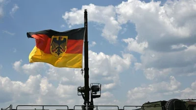 The German flag flies on a military vehicle at the military base of Kaufbeuren, southern Germany, during an Open Day of Germany's armed forces, the Bundeswehr, on June 17, 2023.