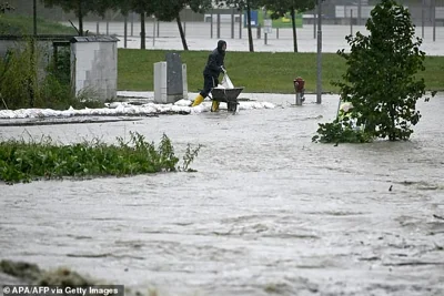 AUSTRIA: A local resident builds flood protection during heavy rainfall in Neulengbach