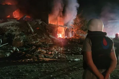 A person stands by damages at the site of an Israeli raid on the southern Lebanese city of Nabatiyeh on October 12, 2024.