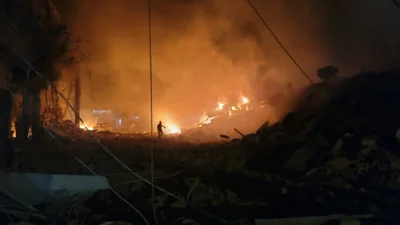 A rescuer searches for survivors at the site of an Israeli airstrike that targeted the southern Lebanese city of Nabatiyeh on October 12, 2024. The official National News Agency (NNA) said "Israeli warplanes... carried out a strike that targeted the centre of the marketplace" in Nabatiyeh, an important south Lebanon city located around 12 kilometres from the border with Israel. (Photo by Abbas FAKIH / AFP)