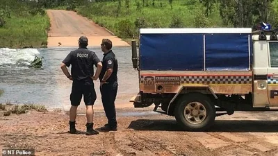 The child was last seen swimming in a creek in the remote Northern Territory community of  Palumpa, 360km south-west of Darwin. (pictured, police at Moyle River crossing between Peppimenarti and Palumpa)