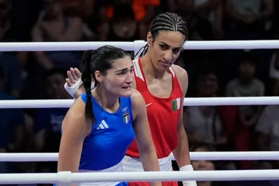 Algeria’s Imane Khelif (red) next to Italy’s Angela Carini, at the end of their women’s boxing match (John Locher/AP)