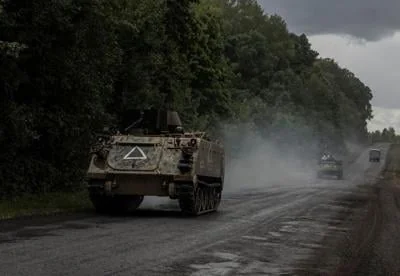 Ukrainian soldiers ride armoured personnel carriers near the Russian border in Sumy region