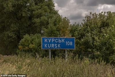 This photograph shows a road sign showing the distance to the Russian town of Kursk next to the destroyed border crossing point with Russia, in the Sumy region, on August 13, 2024