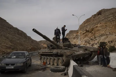 Syrians stand on tank