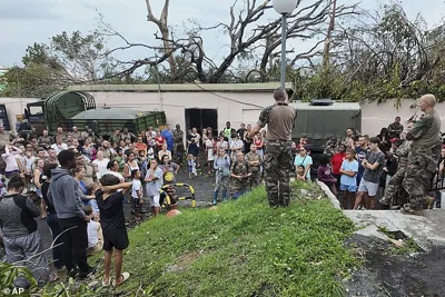 This photo provided Sunday Dec.15, 2024 by the French Army shows soldiers addressing the population in the French territory of Mayotte in the Indian Ocean