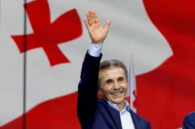 FILE - Billionaire Bidzina Ivanishvili, leader of the Georgian Dream party, greets demonstrators during a rally in Tbilisi, Georgia, on April 29, 2024. (AP Photo/Shakh Aivazov, File)