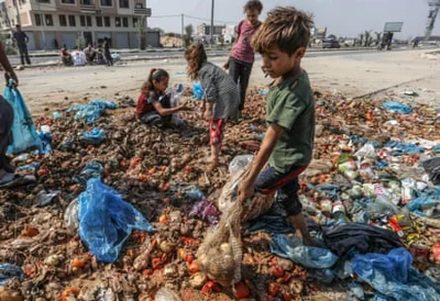 children look for food among garbage