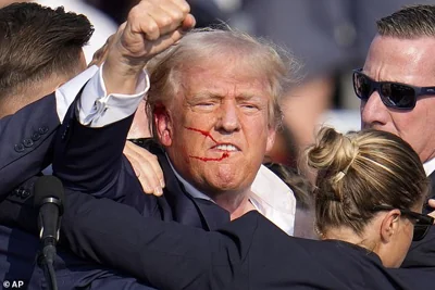 Trump was wounded in the ear but still turned to the crowd and said: 'Fight!'