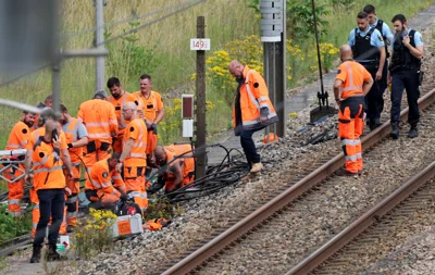 SNCF employees and French gendarmes inspect the scene of a suspected attack on the high speed railway network at Croiselles, northern France on Friday