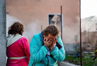 Ukraine shows a Ukrainian woman reacting near the site of an air strike in Odesa, southwestern Ukraine