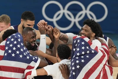 The United States team reacts after winning a men's gold medal basketball game against France at Bercy Arena at the 2024 Summer Olympics, Saturday, Aug. 10, 2024, in Paris, France. AP PHOTO