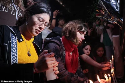 Some were pictured lighting candles and praying for the singer