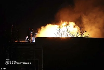 Rescue workers put out a fire of a building which was heavily damaged by a Russian strike on Dnipro, Ukraine