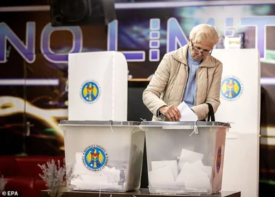 A woman cast her ballot in a polling station in Hrusevo village, Moldova