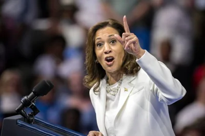 Kamala Harris points at the podium of her rally.