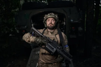A Ukrainian soldier poses in full ammunition