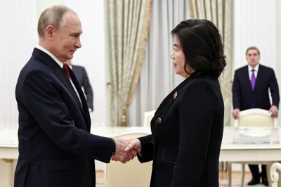 Russian President Vladimir Putin shakes hands with North Korean Foreign Minister Choe Son Hui