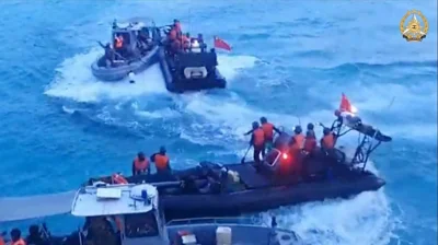 This frame grab from handout video footage taken on June 17, 2024 and released on June 25 by the Armed Forces of the Philippines shows Chinese Coast Guard personnel aboard rigid hull inflatable boats (in black) during a confrontation with Philippine Navy personnel on their respective vessels (in gray) near the Second Thomas Shoal in disputed waters of the South China Sea. The Philippines on June 24 denounced Beijing's 