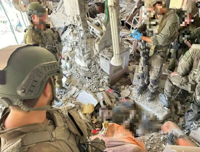 Pictures show Israeli troops gathered around the body believed to be Sinwar