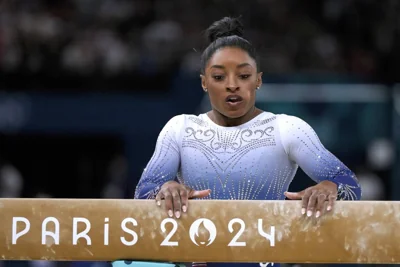 Simone Biles, of the United States, pauses after falling during the women's artistic gymnastics individual balance beam finals at Bercy Arena at the 2024 Summer Olympics, Monday, Aug. 5, 2024, in Paris, France. AP PHOTO