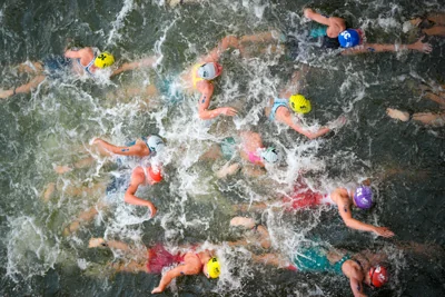 Triathletes swim in the Seine (David Goldman/AP)
