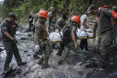 Rescuers recover the body of a policeman who state authorities said died in a car accident while checking damage caused by heavy rain in Alto Lucero, Veracruz, Mexico, Tuesday, July 2, 2024. AP PHOTO