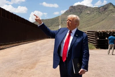 a man pointing at a wall